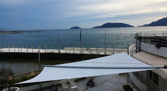 Covering a terrace by the sea with our CoR motorized roller shade sail